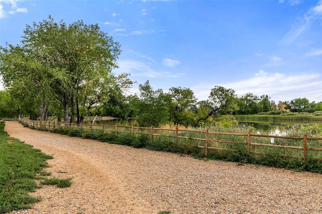 view of yard with a water view and a rural view