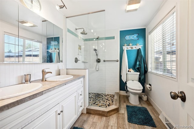 8664 E Monmouth Pl, Denver, CO 80237 - bathroom featuring wood finished floors, a walk in shower, and double vanity