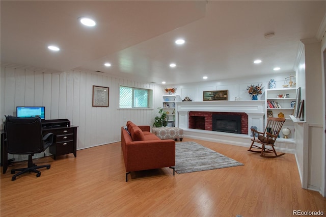 8664 E Monmouth Pl, Denver, CO 80237 - living room with light wood finished floors, an office area, a fireplace, and recessed lighting