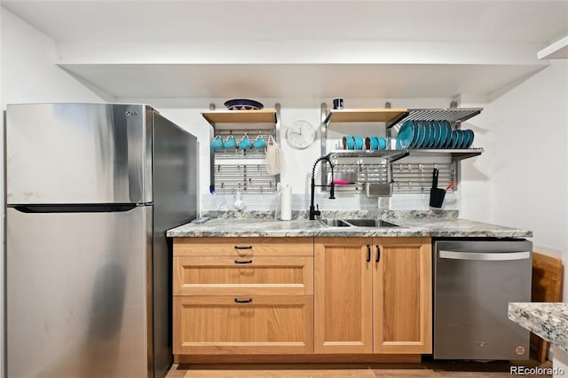 8664 E Monmouth Pl, Denver, CO 80237 - kitchen featuring appliances with stainless steel finishes, open shelves, light stone countertops, and light wood-style floors