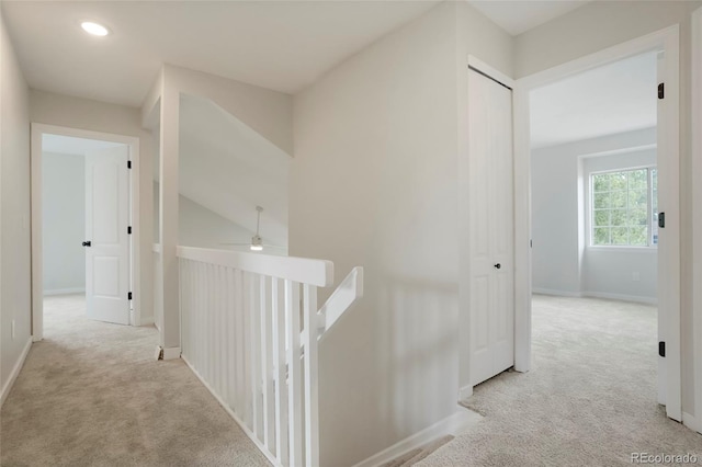 hallway with light colored carpet