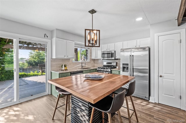 4512 S Yank St, Morrison, CO 80465 - kitchen with appliances with stainless steel finishes, light countertops, light wood-type flooring, a chandelier, and recessed lighting