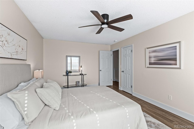 4512 S Yank St, Morrison, CO 80465 - bedroom with dark wood-type flooring, a textured ceiling, and a ceiling fan