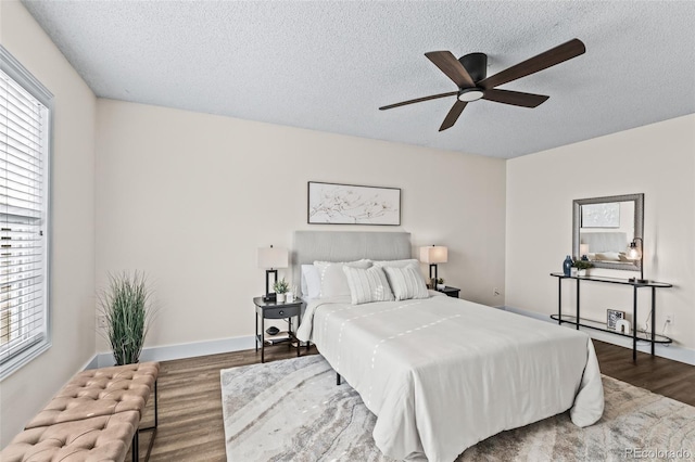4512 S Yank St, Morrison, CO 80465 - bedroom with a textured ceiling, dark wood-style flooring, multiple windows, and ceiling fan