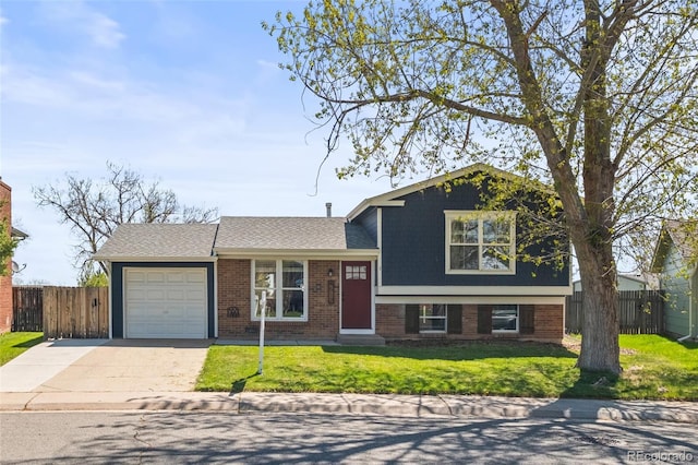 4512 S Yank St, Morrison, CO 80465 - split level home featuring an attached garage, concrete driveway, and brick siding