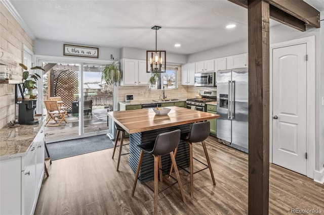 4512 S Yank St, Morrison, CO 80465 - kitchen with appliances with stainless steel finishes, wooden counters, wood finished floors, healthy amount of natural light, and recessed lighting