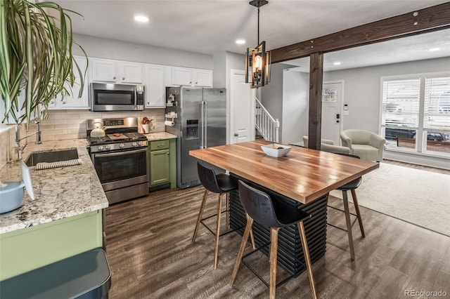 4512 S Yank St, Morrison, CO 80465 - kitchen featuring appliances with stainless steel finishes, recessed lighting, backsplash, white cabinetry, and green cabinetry