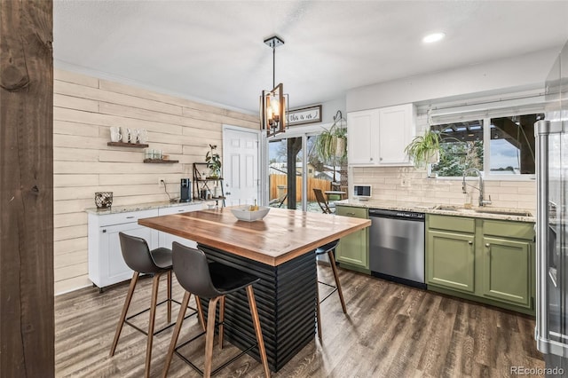 4512 S Yank St, Morrison, CO 80465 - kitchen featuring dishwasher, green cabinetry, plenty of natural light, dark wood-style flooring, and wooden walls
