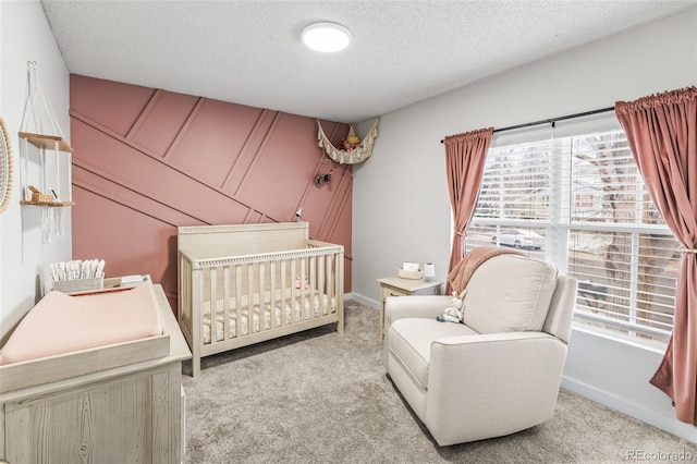 4512 S Yank St, Morrison, CO 80465 - bedroom featuring multiple windows, light carpet, a textured ceiling, and a crib