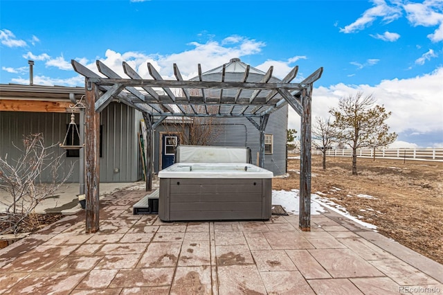 view of patio with a pergola, fence, and a hot tub