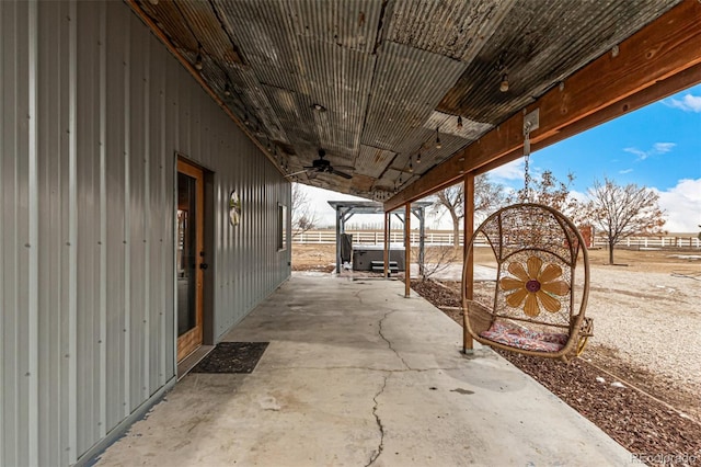 view of patio / terrace with ceiling fan and fence