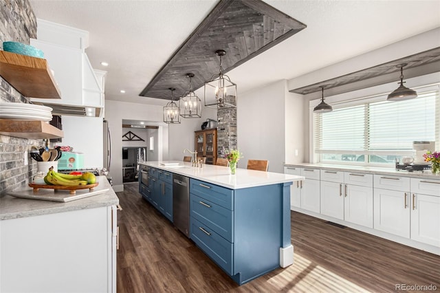 kitchen featuring blue cabinets, light countertops, white cabinets, and a sink