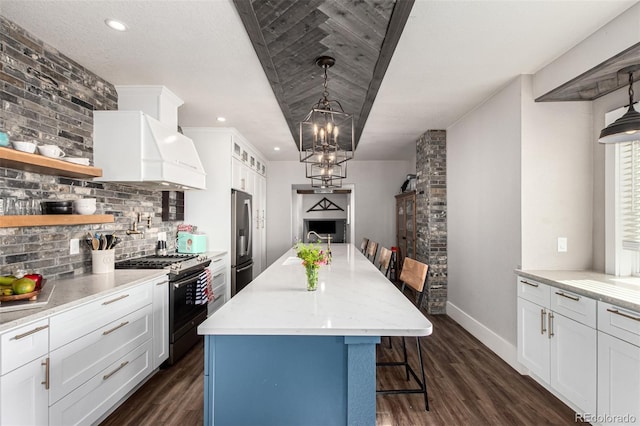 kitchen featuring premium range hood, appliances with stainless steel finishes, dark wood-style floors, and a kitchen breakfast bar