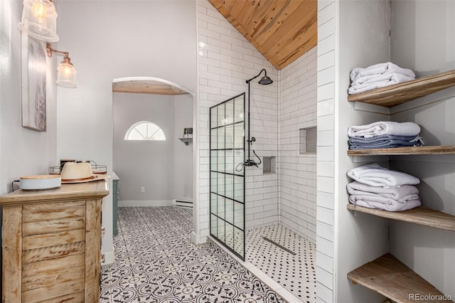 full bath with a baseboard heating unit, wood ceiling, vaulted ceiling, a walk in shower, and baseboards