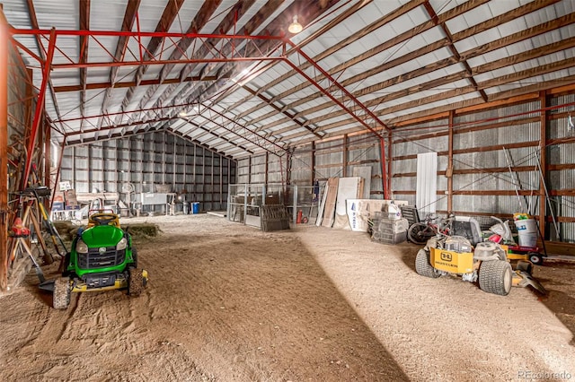 miscellaneous room featuring vaulted ceiling and metal wall