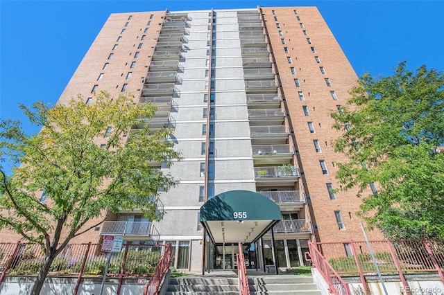 view of building exterior with fence