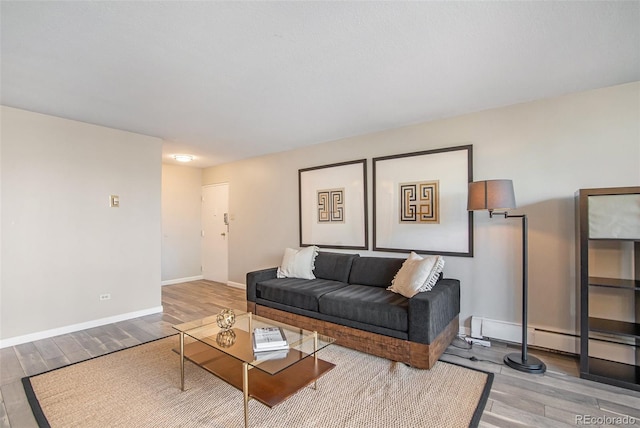 living area featuring baseboards and wood finished floors