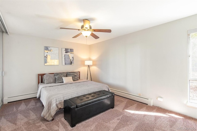 bedroom with baseboard heating, a ceiling fan, and carpet floors