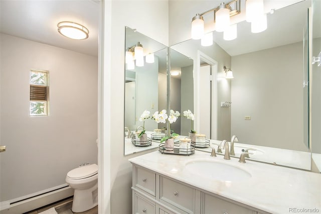 bathroom with a baseboard heating unit, toilet, and vanity