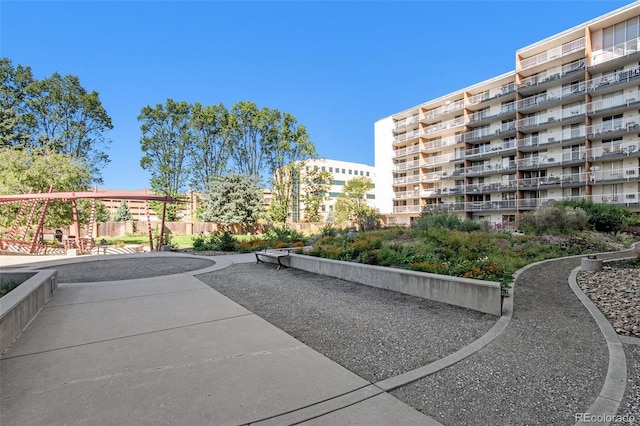 view of community featuring fence and a patio area