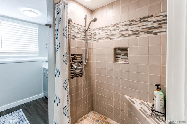 bathroom featuring wood-type flooring and a shower with curtain