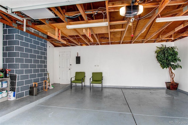 garage featuring a garage door opener and electric panel