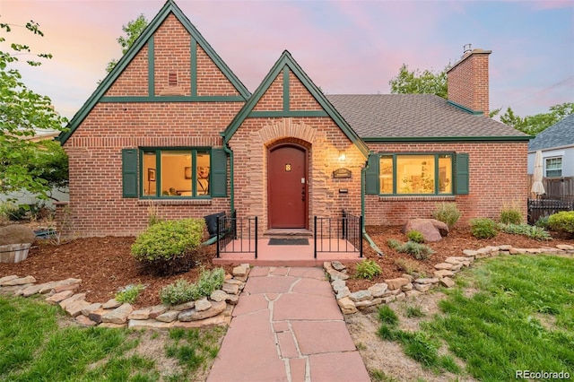 tudor-style house featuring a porch