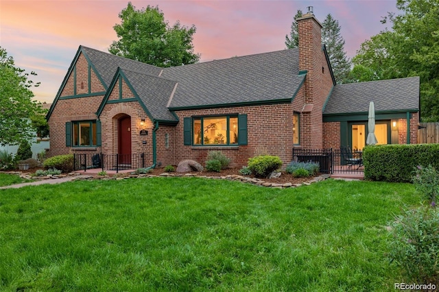 tudor home featuring a lawn