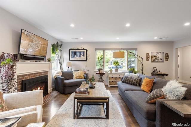 living room with hardwood / wood-style flooring and a fireplace