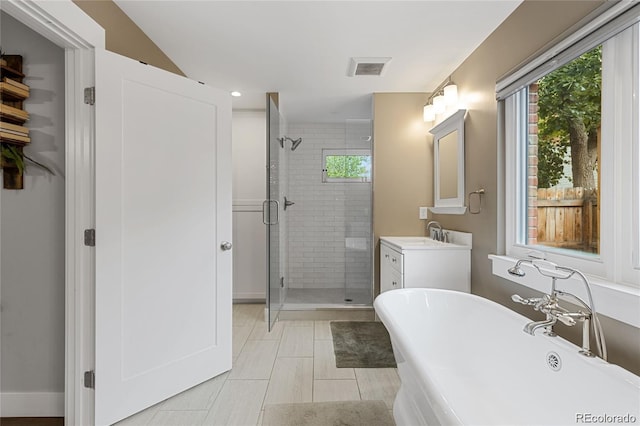 bathroom with vanity and separate shower and tub