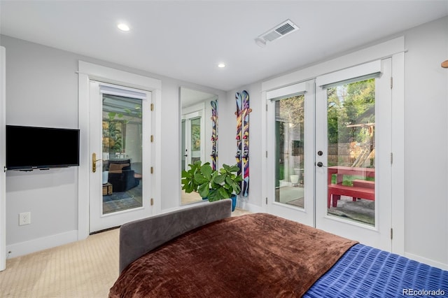 bedroom featuring light colored carpet and access to exterior