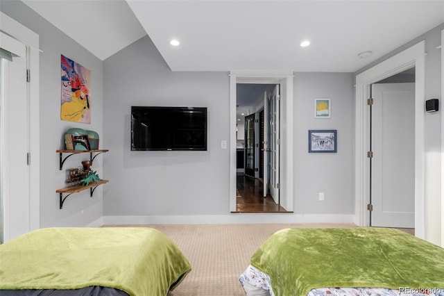 bedroom with vaulted ceiling and carpet flooring