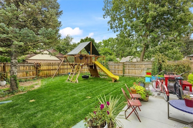 view of yard with a playground and a patio