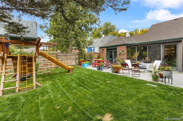 view of yard with a patio area and a playground