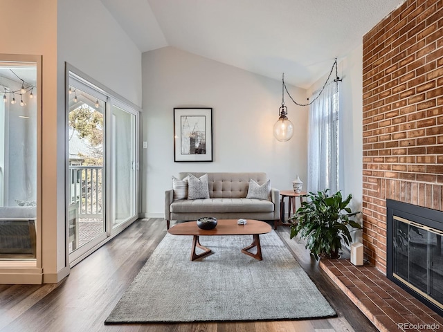 living room featuring a fireplace, dark wood-type flooring, and lofted ceiling