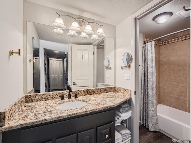 bathroom with shower / bath combination with curtain, vanity, a textured ceiling, and hardwood / wood-style floors