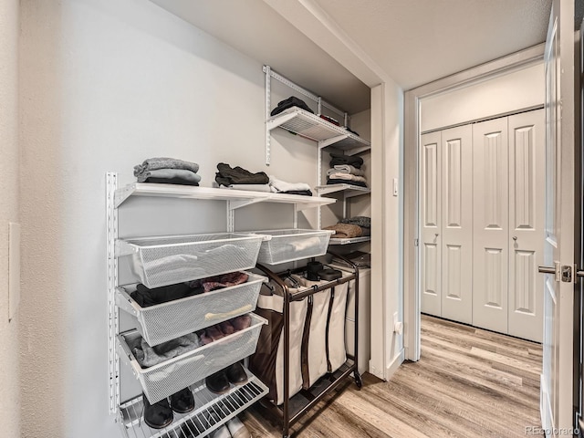 spacious closet with light hardwood / wood-style floors