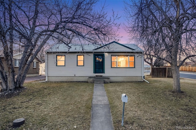 bungalow-style house with a lawn