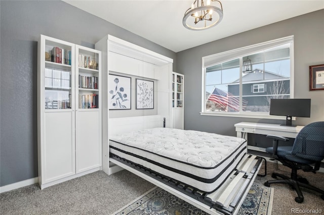 carpeted bedroom with a notable chandelier and baseboards