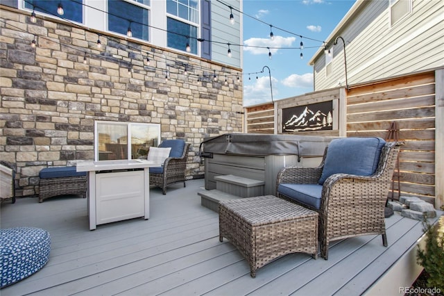 wooden deck with a hot tub