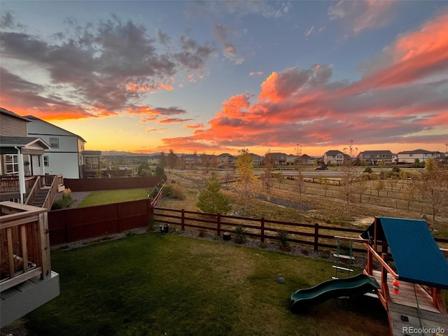 view of yard with a playground and a fenced backyard