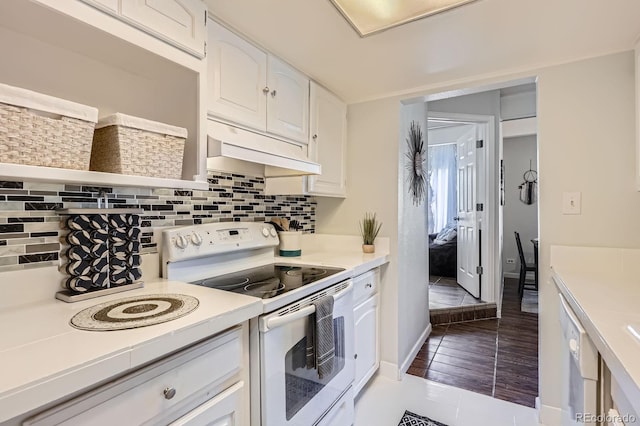 kitchen featuring white appliances, under cabinet range hood, white cabinetry, and light countertops