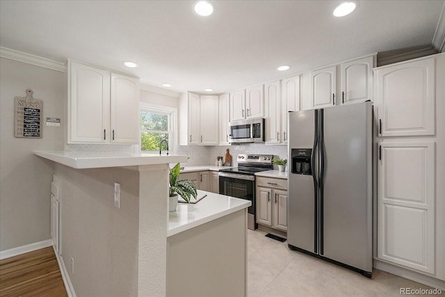 1705 W Stoll Pl, Denver, CO 80221 - kitchen with stainless steel appliances, a peninsula, crown molding, white cabinets, and light countertops