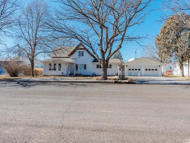 view of front facade featuring a garage and an outdoor structure