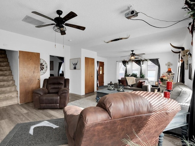 317 Adams Ave, Akron, CO 80720 - living room featuring a textured ceiling, light hardwood / wood-style flooring, and ceiling fan