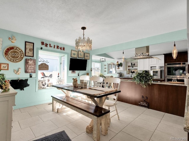 317 Adams Ave, Akron, CO 80720 - tiled dining space featuring a textured ceiling and a notable chandelier