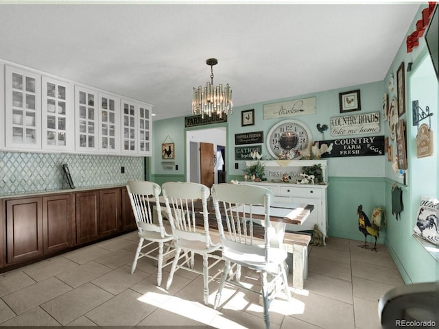 317 Adams Ave, Akron, CO 80720 - dining space featuring light tile patterned flooring and a chandelier