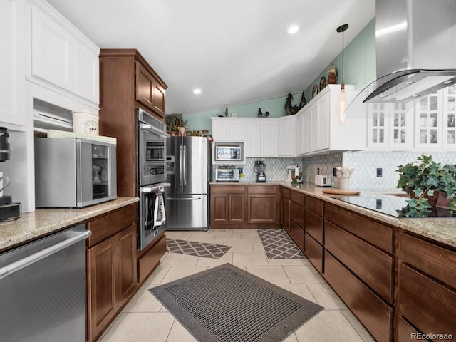 317 Adams Ave, Akron, CO 80720 - kitchen featuring tasteful backsplash, decorative light fixtures, stainless steel appliances, range hood, and white cabinets