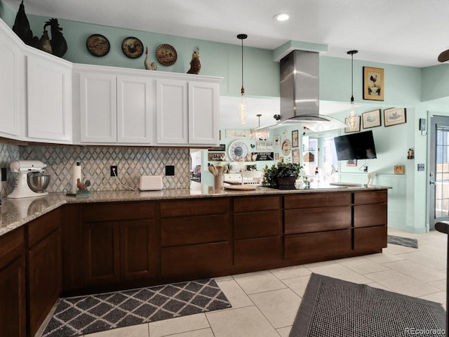 317 Adams Ave, Akron, CO 80720 - kitchen featuring pendant lighting, island range hood, and white cabinets