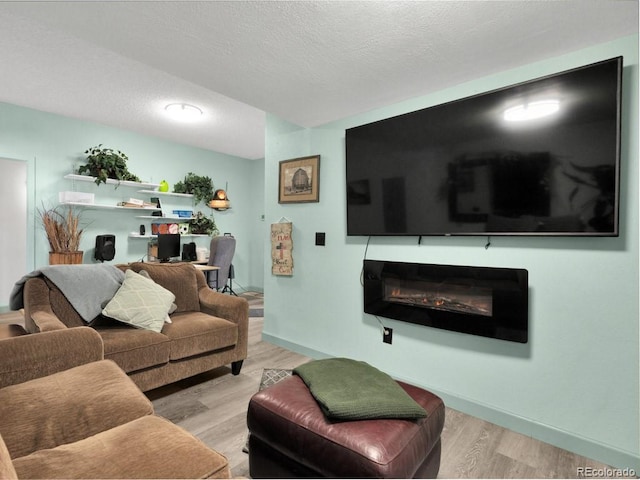 317 Adams Ave, Akron, CO 80720 - living room with a textured ceiling and light wood-type flooring